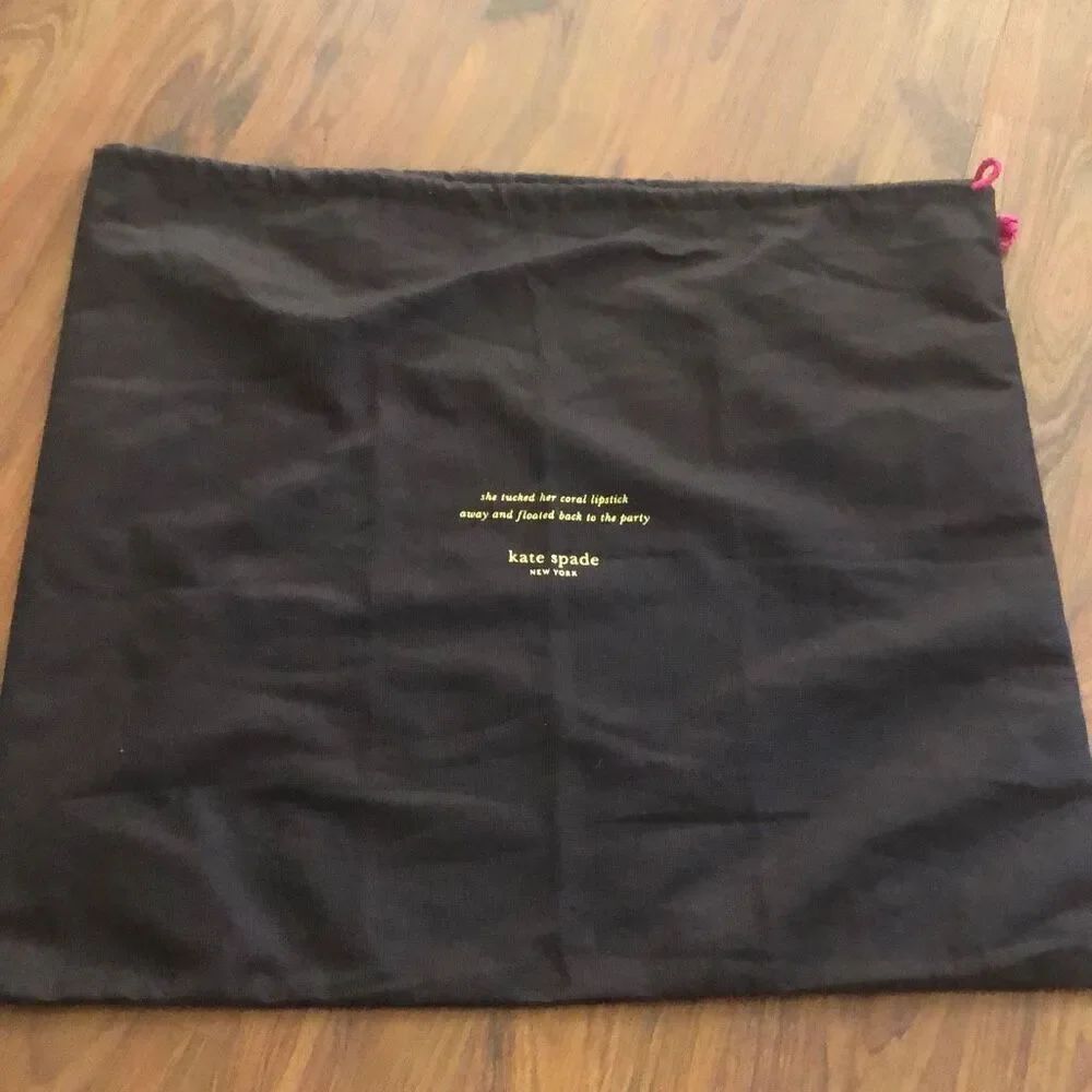 Kate Spade brown and pink dust bag “ She tucked her coral lipstick away and floa